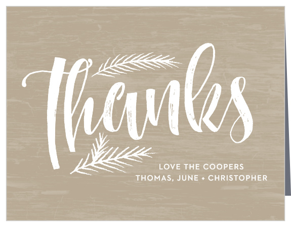 A rustic background sits behind pine needles on the White Pine Holiday Thank You Cards.