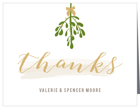 On our Mistletoe Soiree Foil Holiday Thank You Cards, below a traditional bundle of mistletoe, we've sketched "thanks" in a curving script.