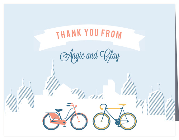 Our City Life Thank You Cards feature the same beautiful design as the primary invitations in the City Life wedding suite: a great white banner high in the sky, your appreciation written in a lovely, modern orange; the silhouette of a vast cityscape in the background, and; a pair of bicycles in stunning yellow and orange decorating the foreground.