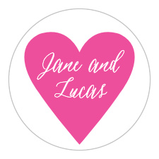 The Heart Beat Wedding Stickers feature a simple, curling calligraphy inscribed onto a cerise heart.