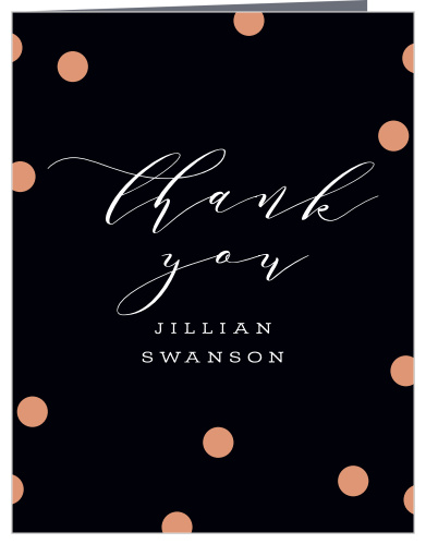 Rose gold foiled confetti sits atop a rich black background.