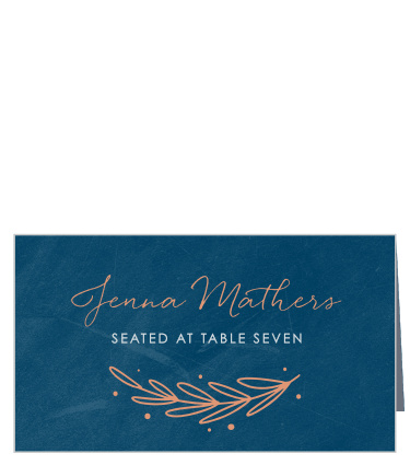 Guide your guests to their seats with the shining foil beacon of our Once Upon a Time Place Cards. Your loved ones' names are spelled out in a flowing calligraphy through the center of the page, the elegant shimmer of foil in every letter, while a botanical illustration cradles the white print of your table number. 