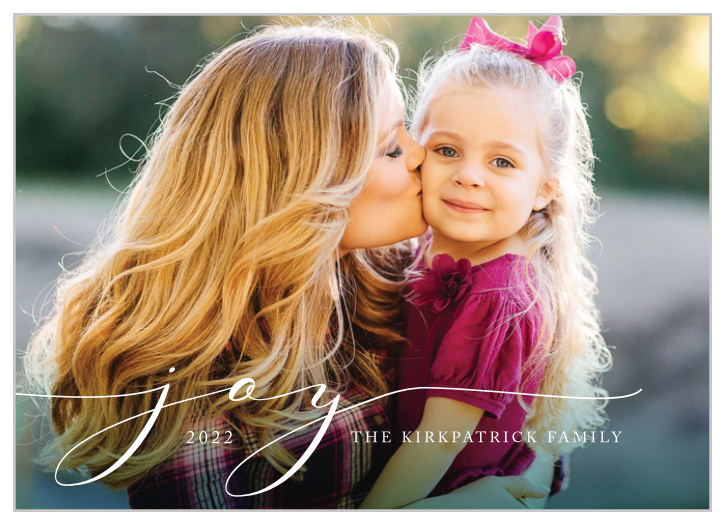 Our Scripted Joy Holiday Cards offer a minimalist design for those who want to keep it simple this holiday season.  Your photo serves as the background of the card, with a dark green border at the bottom fading upwards toward the text.  Sweeping cursive letters spell out "joy", but you can include your own customized holiday well-wishes and your family name.  These holiday cards are dignified in their simplicity and clean design.